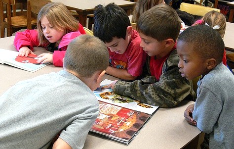 Group of children looking at library books